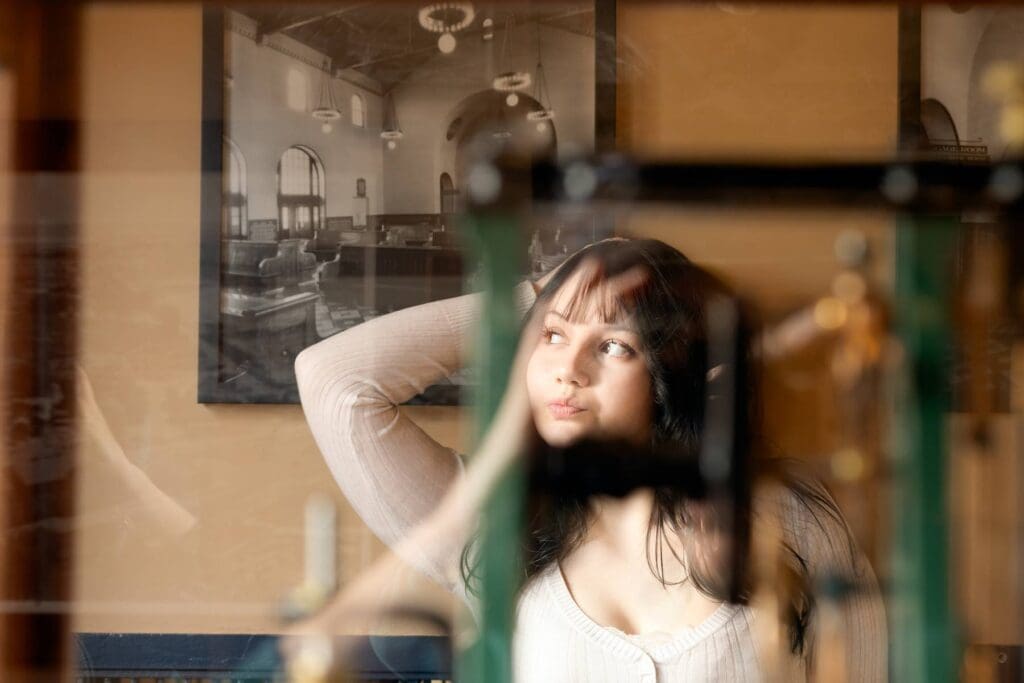 High school senior looking to the side with glass glare.